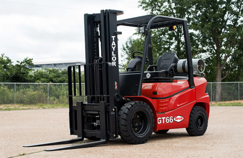 Parking lot with many forklifts lined up in rows.